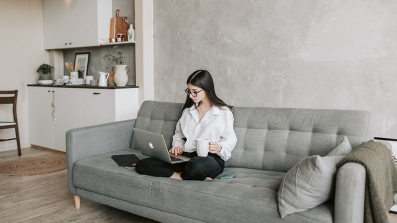 woman sitting on sofa while working at home 4050295