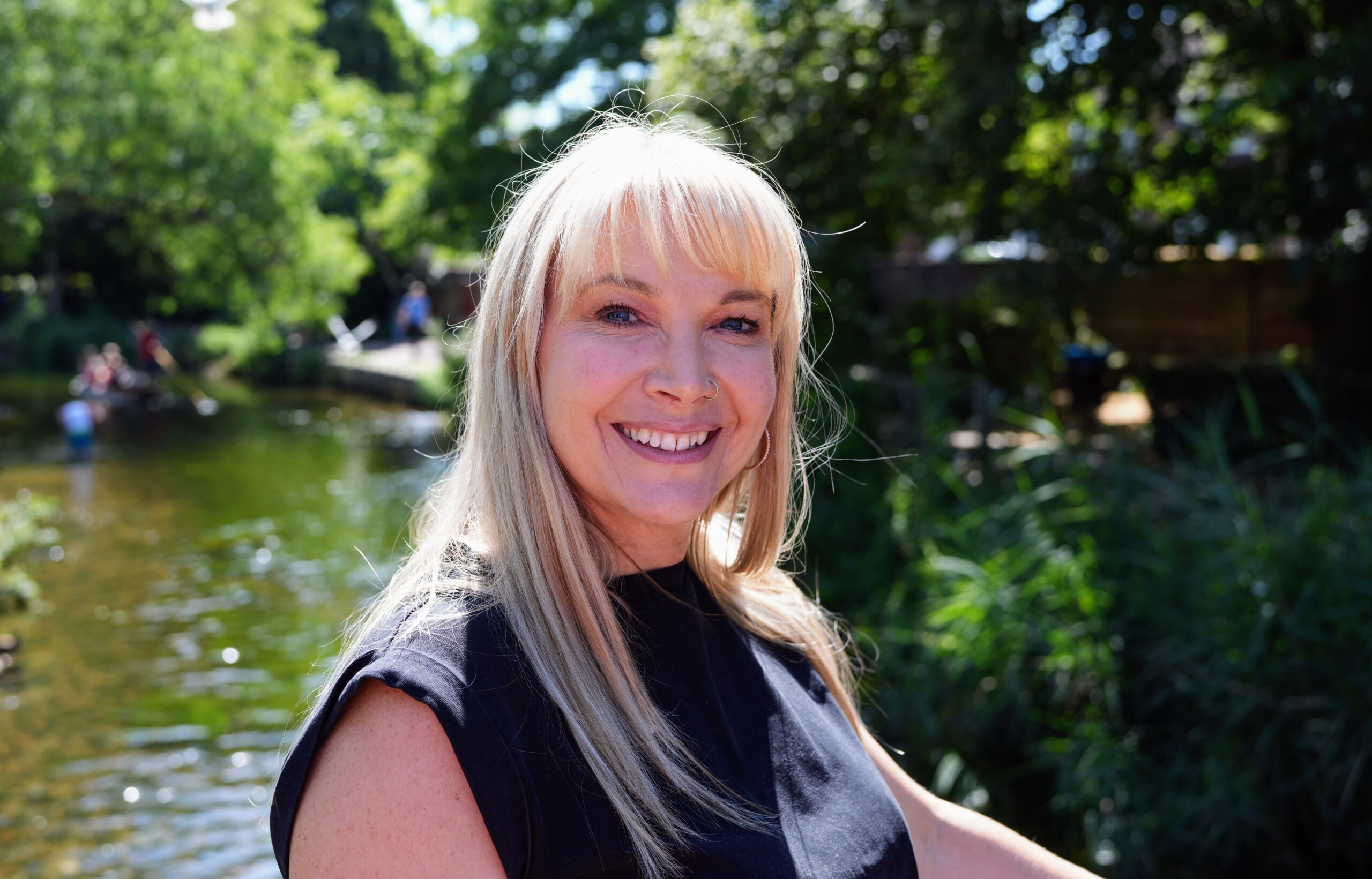Becky Stone smiling at Westgate Gardens beside the River Stour in Canterbury, Kent.